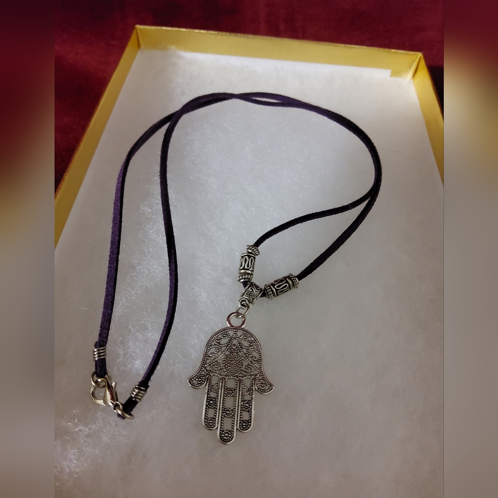One Earth Hamsa Necklace On A Purple Suede Cord